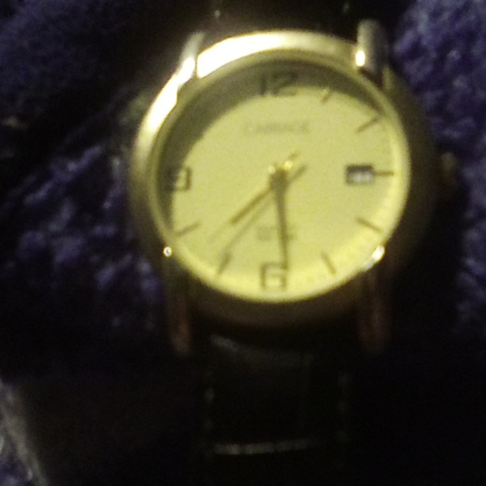 A Timex carriage women's watch it's gold and black and vintage